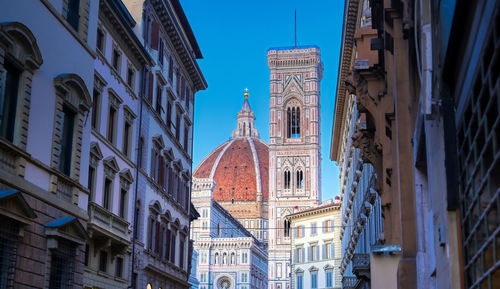 Low angle view of cathedral by buildings in city