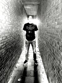 Rear view of man walking in front of building