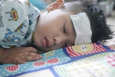 Portrait of cute baby lying on bed