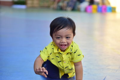 Portrait of cute boy against water