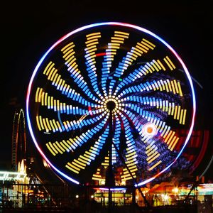 Low angle view of illuminated ferris wheel