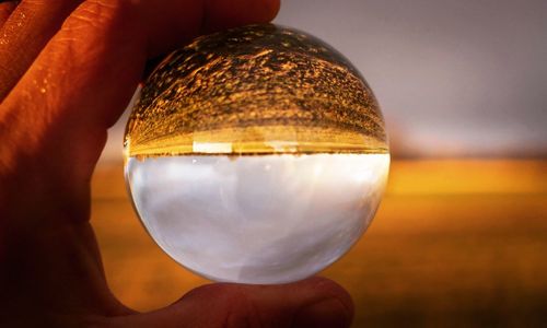 Close-up of hand holding crystal ball