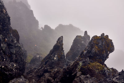 Rock formations on mountain against sky