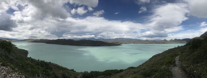 Panoramic view of sea and mountains against sky