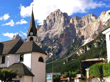 Panoramic view of church and houses against sky