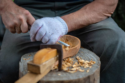 Midsection of carpenter working in carpentry workshop