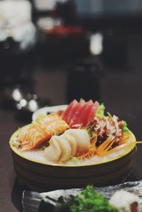 Close-up of sashimi served in bowl on table