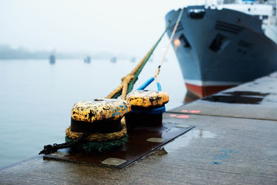Close-up of rope tied to boat moored in sea