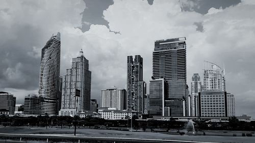 City buildings against cloudy sky