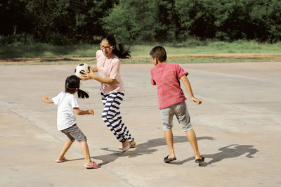 Mother playing with children at park