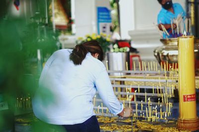 Rear view of woman standing at market