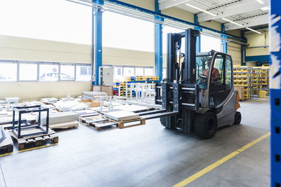 Man on forklift in factory warehouse