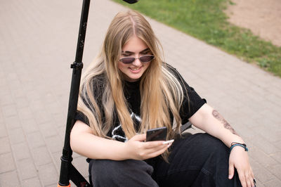 Portrait of young woman using mobile phone