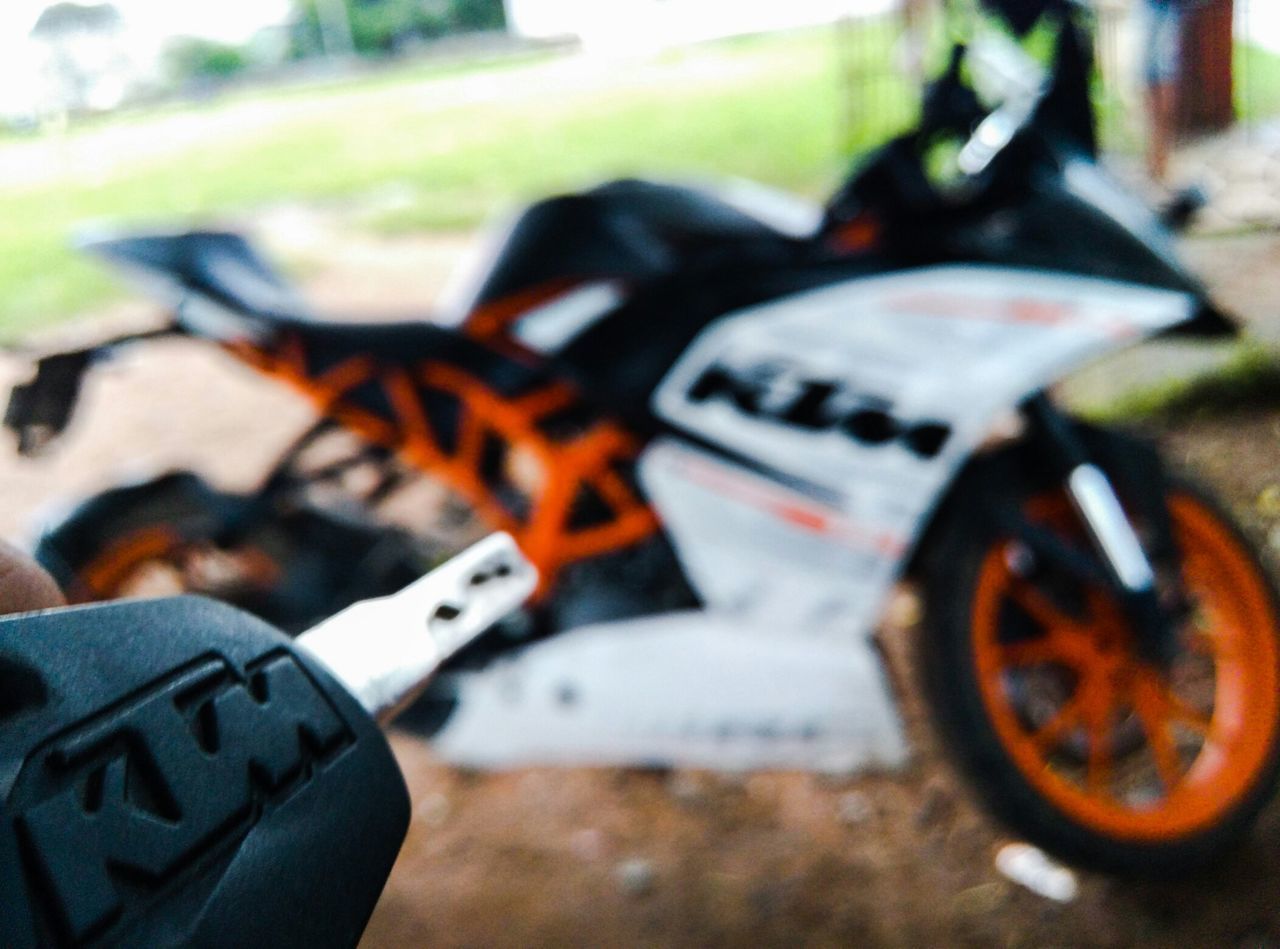 land vehicle, transportation, focus on foreground, mode of transport, close-up, car, bicycle, selective focus, part of, stationary, day, street, outdoors, field, motorcycle, cropped, wheel, grass, shoe, no people