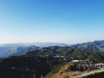 Scenic view of mountains against clear blue sky