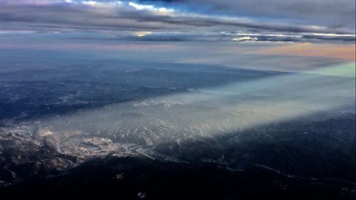 Aerial view of sea and landscape against sky