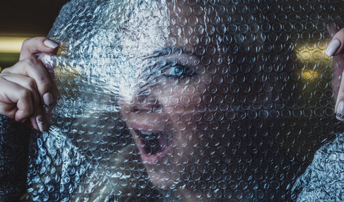 Close-up portrait of woman with bubble wrap