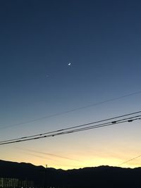 Low angle view of silhouette birds flying against sky during sunset