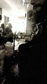 Close-up of hand with drink at night