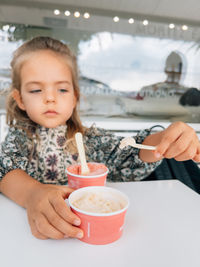 Cropped hand of woman holding ice cream