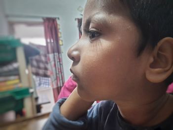 Portrait of boy looking away at home