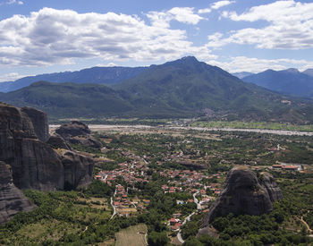 Scenic view of mountain range against cloudy sky