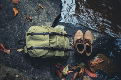 High angle view of shoes and backpack at lake