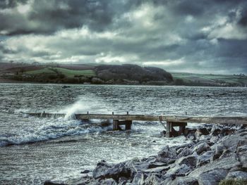 Scenic view of sea against cloudy sky