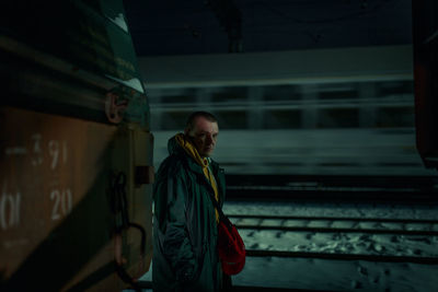 Young man looking at camera at night