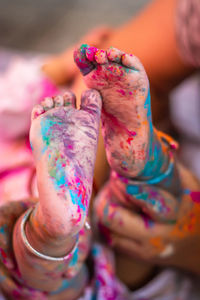 Infant little colorful feet at holi from unique angle