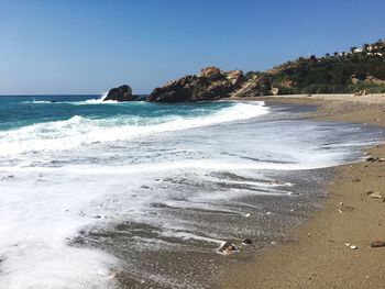 Scenic view of beach against clear sky