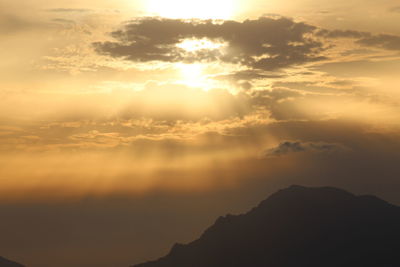 Low angle view of silhouette mountains against sky during sunset