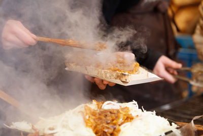 Midsection of man preparing food