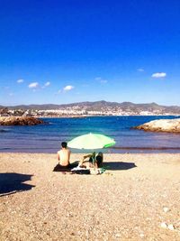 Scenic view of beach against blue sky