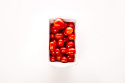 High angle view of tomatoes against white background