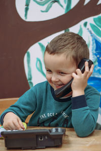 Portrait of boy playing with toy car