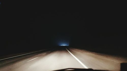 Illuminated tunnel at night