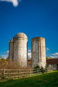 Old building in field against blue sky