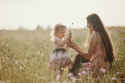 Mother and daughter on field