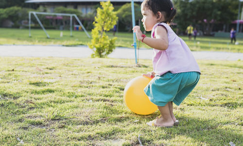 Boy playing with ball on grass