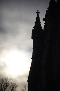 Low angle view of building against cloudy sky