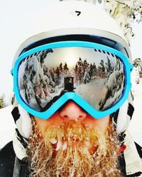 Close-up of sunglasses against clear sky during winter