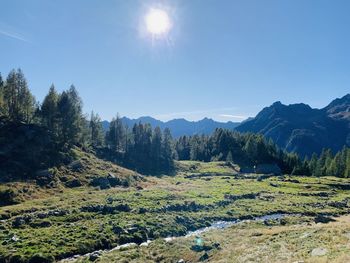 Scenic view of mountains against sky on sunny day