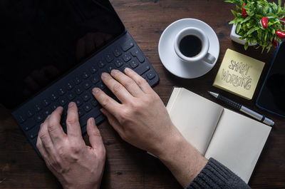 High angle view of woman using laptop on table