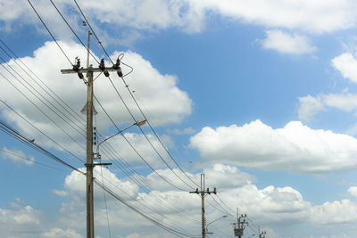 Low angle view of electricity pylon against sky