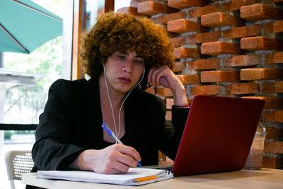 Portrait of woman using laptop at table