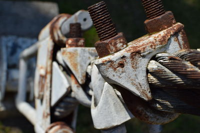 Detail of rusty nuts and bots with steel cable