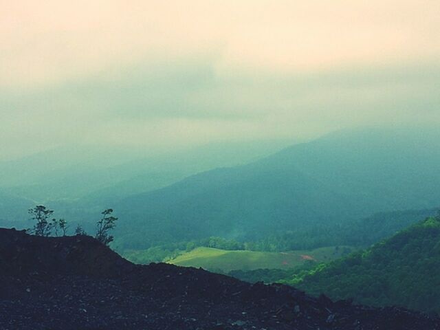 mountain, tranquil scene, tranquility, scenics, mountain range, landscape, beauty in nature, sky, nature, fog, non-urban scene, idyllic, remote, cloud - sky, hill, weather, outdoors, day, no people, horizon over land