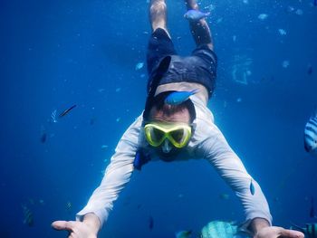 Young woman swimming underwater