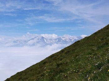 Scenic view of mountains against blue sky